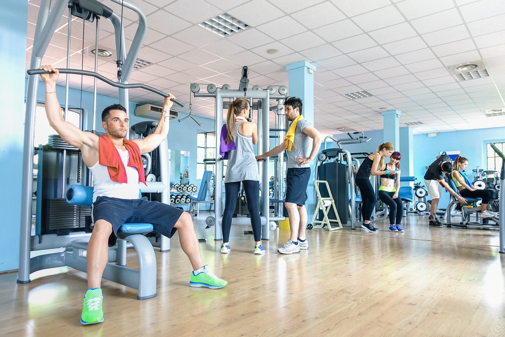 Small group of sportive friends at gym fitness club center